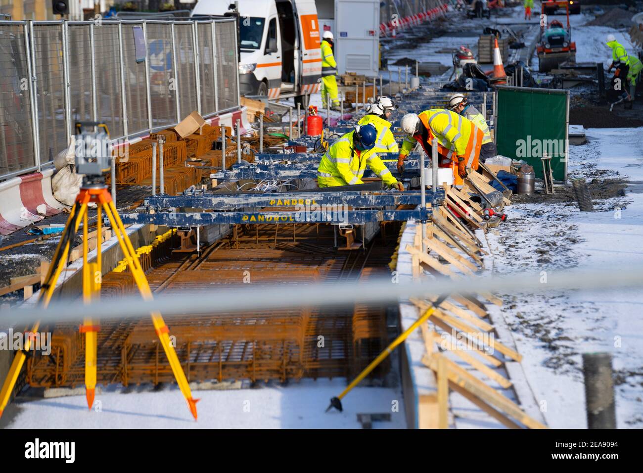 Edinburgh, Scotland, UK. 8 Feb 2021.  Construction workers installing tram tracks as part of the Trams to Newhaven project in Leith, Edinburgh.  Iain Masterton/Alamy Live news Stock Photo