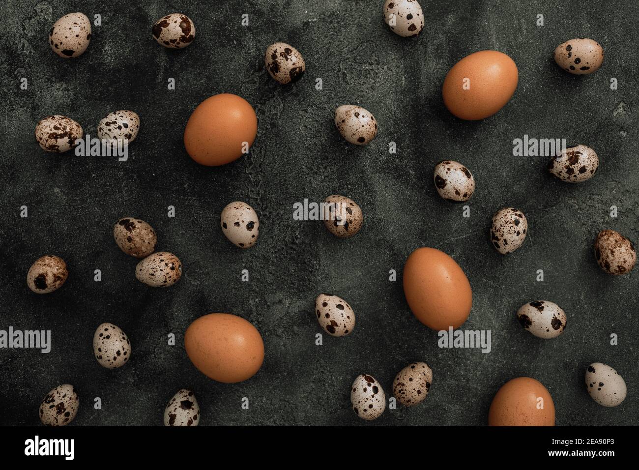 Stylish pattern with Easter eggs isolated on dark gray background. Flat lay, Top view. Easter holiday concept. Stock Photo