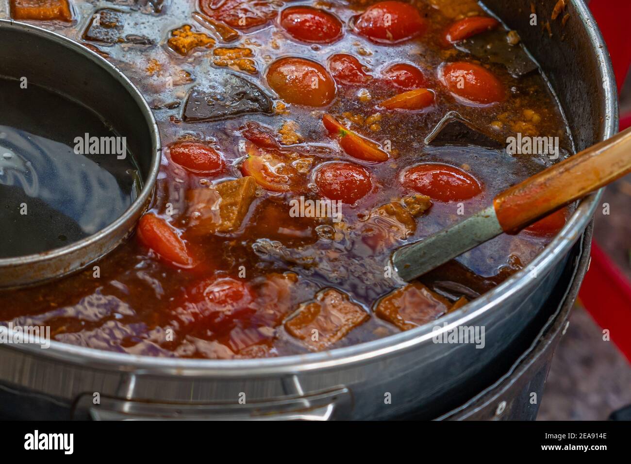 Pot of crab paste and tomato soup at street food vendor Stock Photo