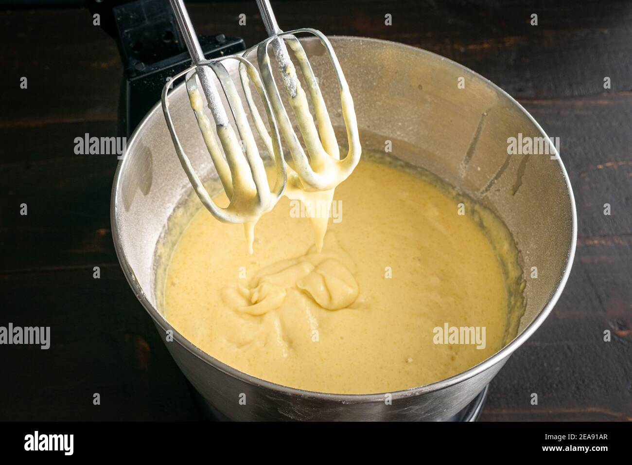 Closeup of Stand Mixer Beaters in Above Vanilla Cake Batter: Cake batter that has been mixed in an electric stand mixer bowl Stock Photo