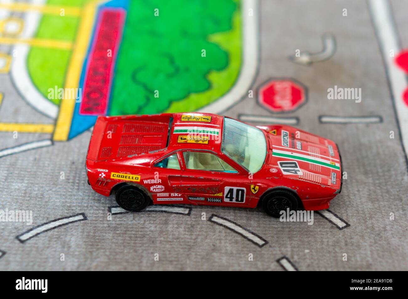 POZNAN, POLAND - Sep 10, 2018: Red toy model Ferrari sport car on a road mat Stock Photo