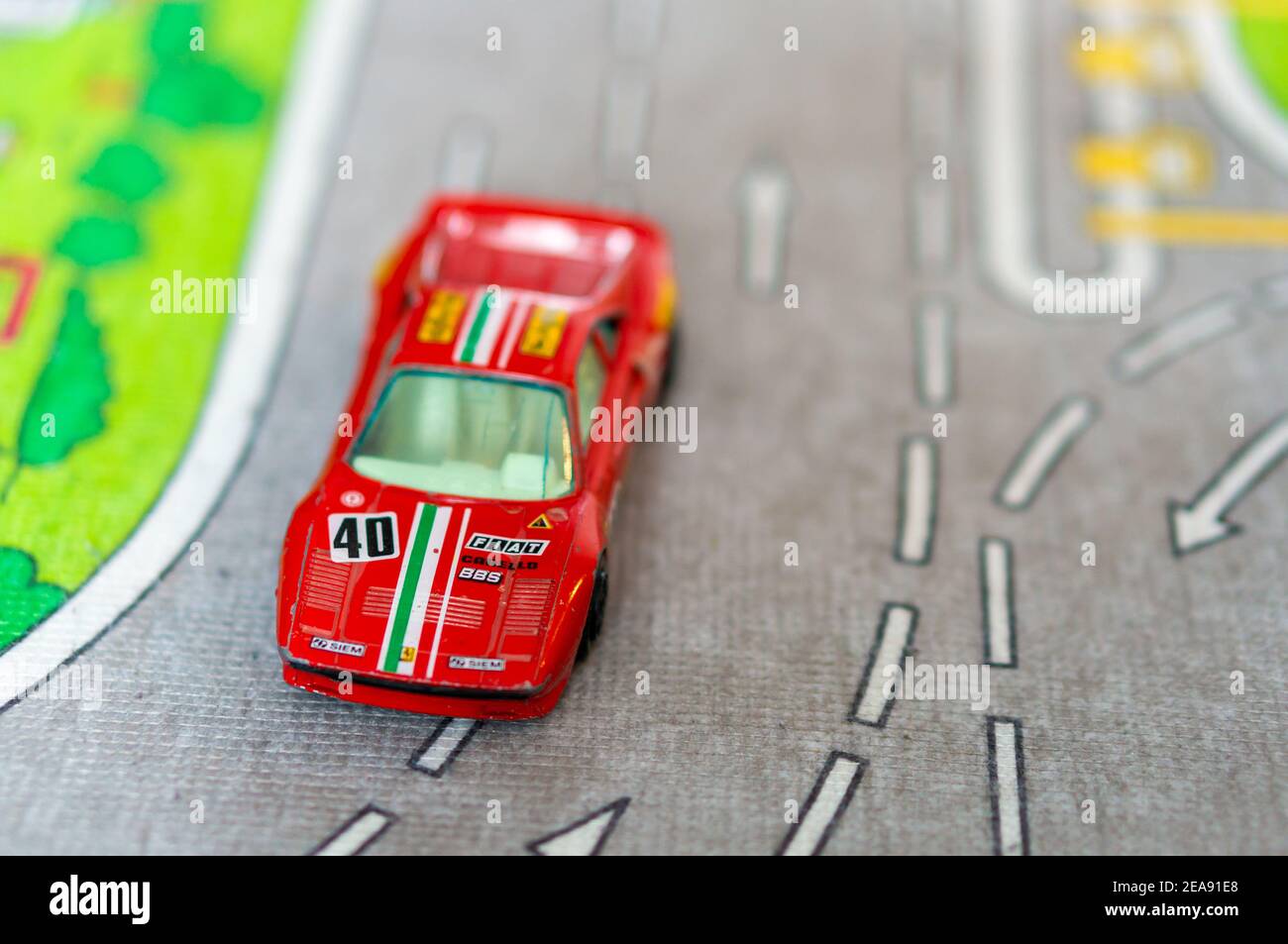 POZNAN, POLAND - Sep 10, 2018: Red toy model Ferrari sport car on a road mat Stock Photo