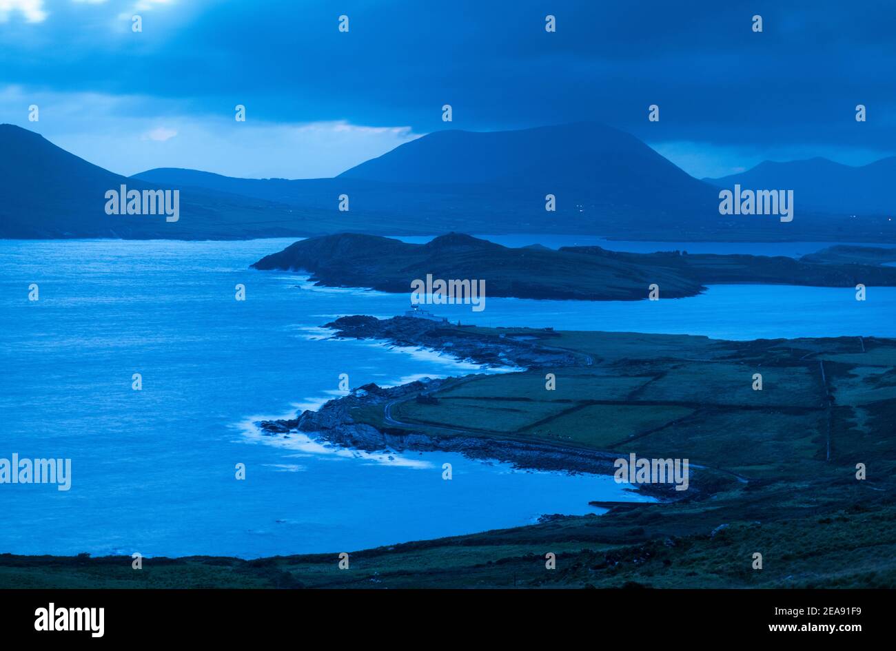 Waves break in predawn hours at Valentia Island Lighthouse on Cromwell Point, Valentia, Ireland. Stock Photo