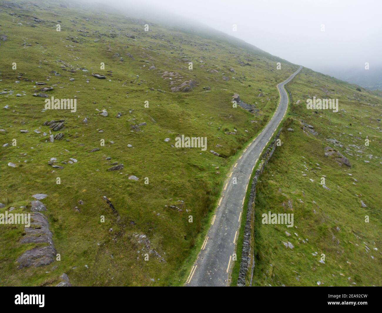 A winding rural mountainous road (R574) on the Ring of Beara in County Kerry, Ireland. Stock Photo