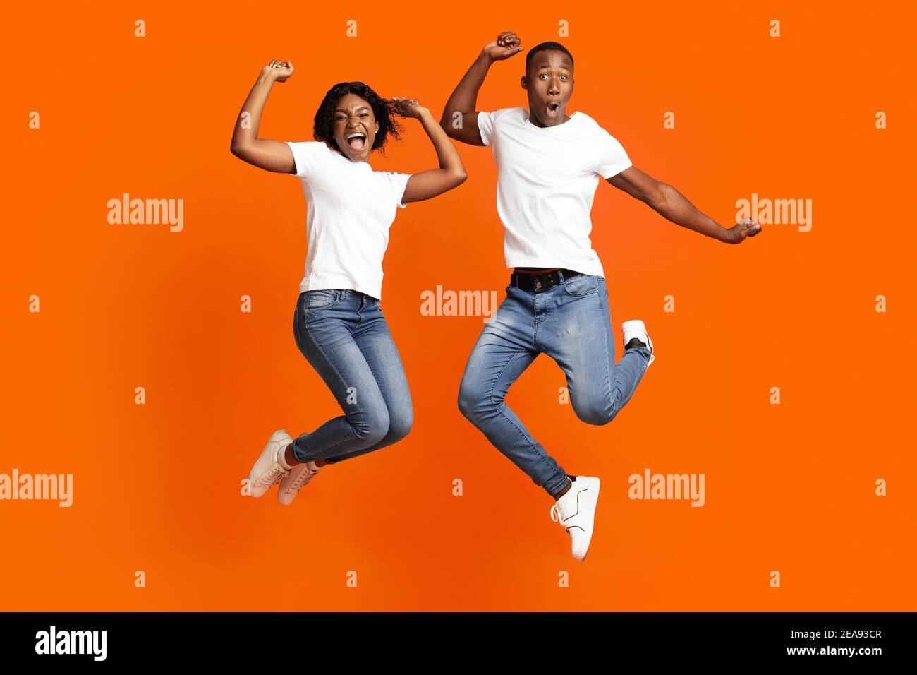Happy black man and woman celebrating success, full length photo Stock Photo