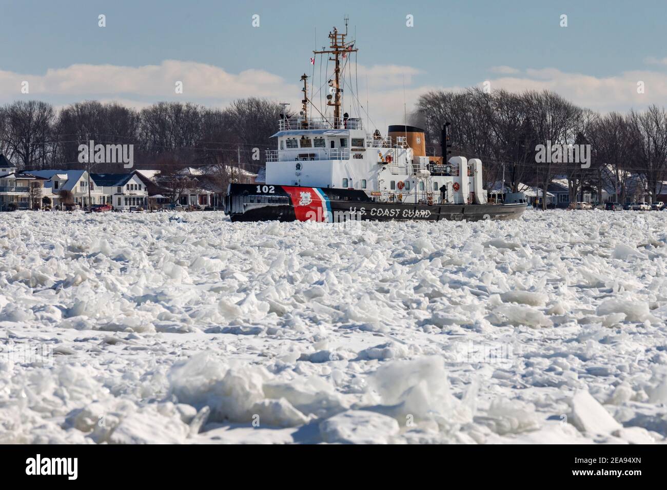 Roberts Landing, Michigan, USA. 7th Feb, 2021. The U.S. Coast Guard Cutter Bristol Bay breaks up ice on the St. Clair River. Bitter cold has led to ice jams on the river and flooding in shoreline communities. The St. Clair River is the border between the U.S. and Canada; it drains the upper Great Lakes towards Lake St. Clair and on to Lake Erie. Credit: Jim West/Alamy Live News Stock Photo