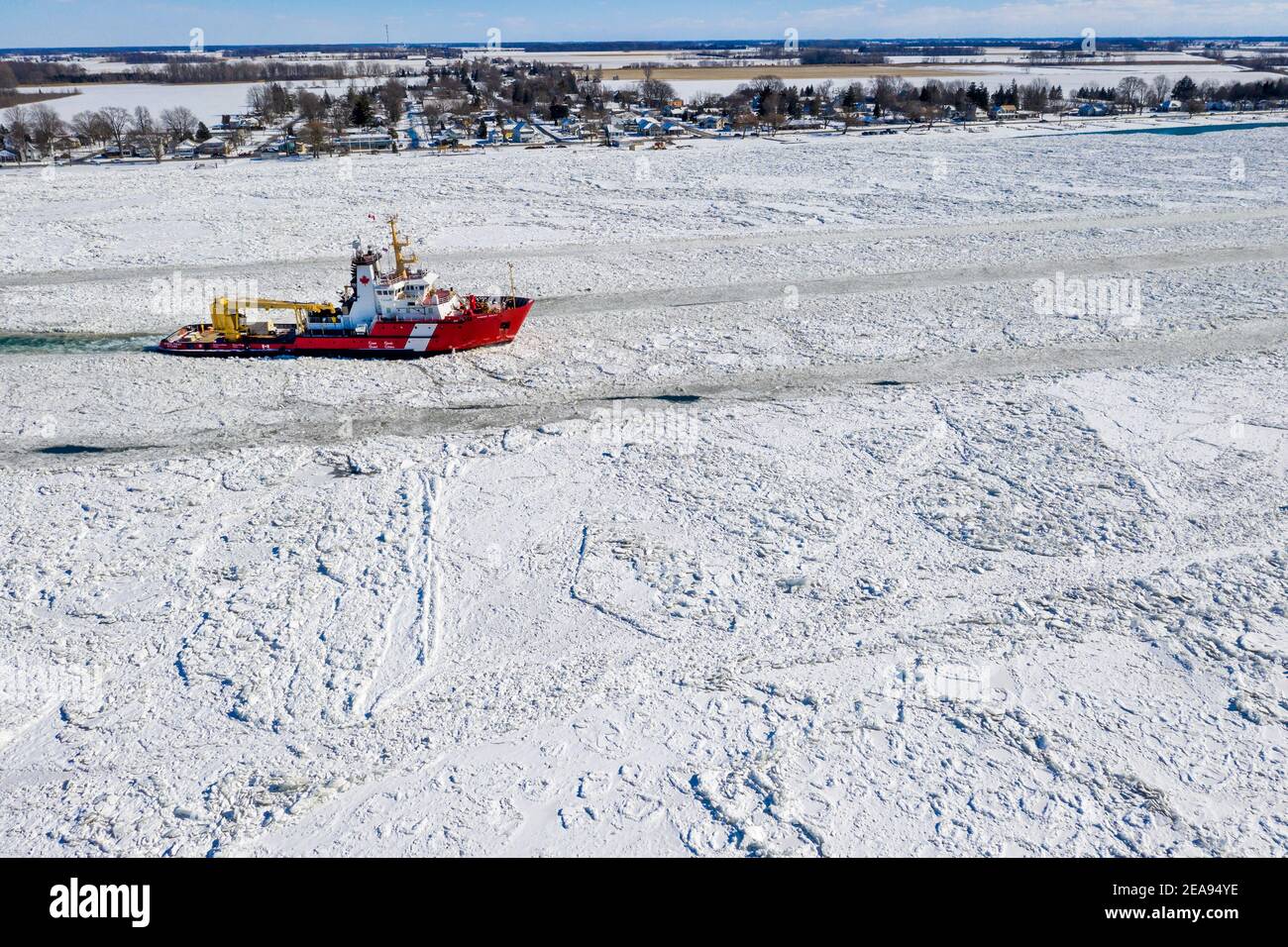 Roberts Landing, Michigan, USA. 7th Feb, 2021. The Canadian Coast Guard icebreaker Samuel Risley breaks up ice on the St. Clair River. Bitter cold has led to ice jams on the river and flooding in shoreline communities. The St. Clair River is the border between the U.S. and Canada; it drains the upper Great Lakes towards Lake St. Clair and on to Lake Erie. Credit: Jim West/Alamy Live News Stock Photo