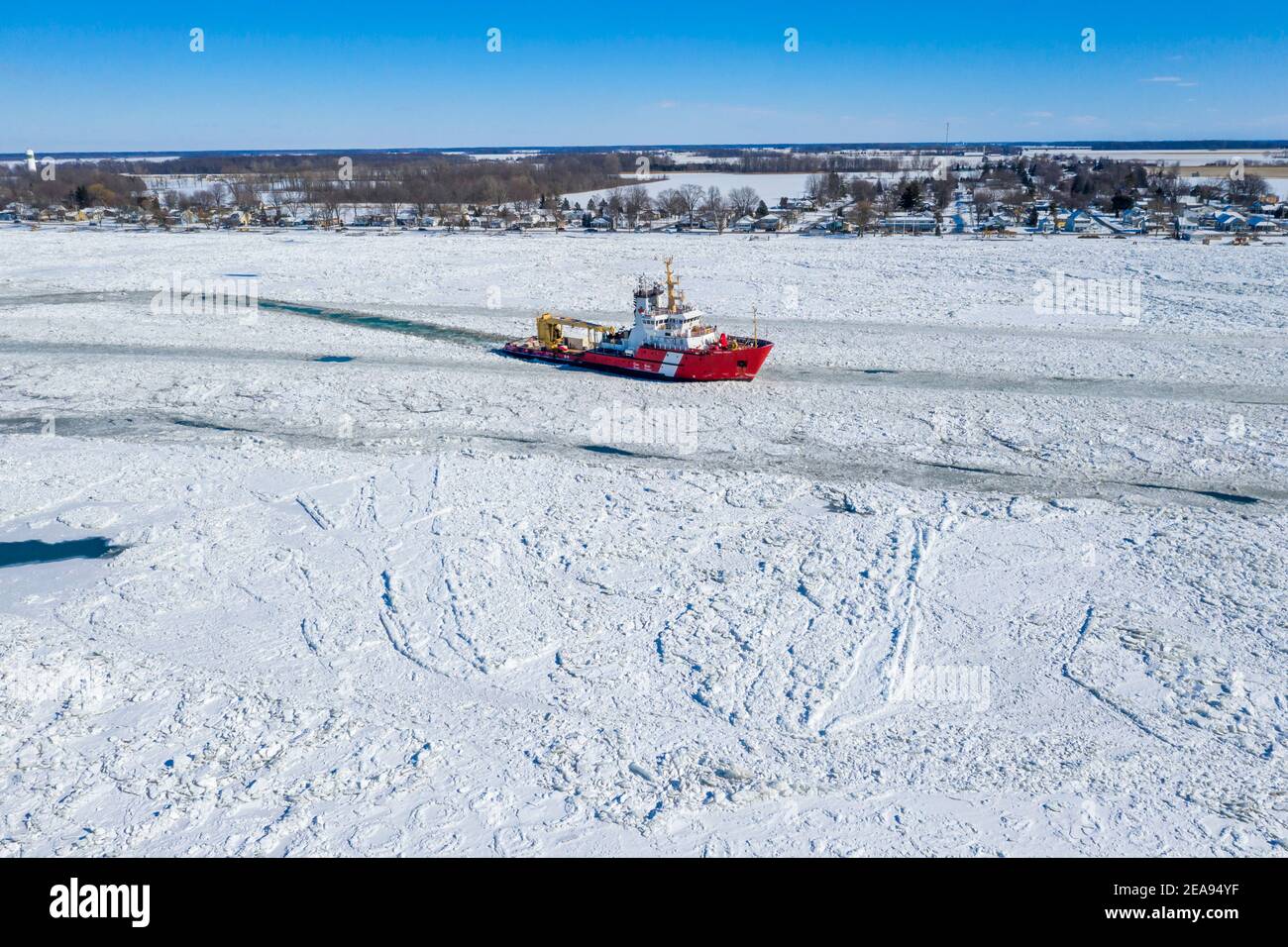 Roberts Landing, Michigan, USA. 7th Feb, 2021. The Canadian Coast Guard icebreaker Samuel Risley breaks up ice on the St. Clair River. Bitter cold has led to ice jams on the river and flooding in shoreline communities. The St. Clair River is the border between the U.S. and Canada; it drains the upper Great Lakes towards Lake St. Clair and on to Lake Erie. Credit: Jim West/Alamy Live News Stock Photo