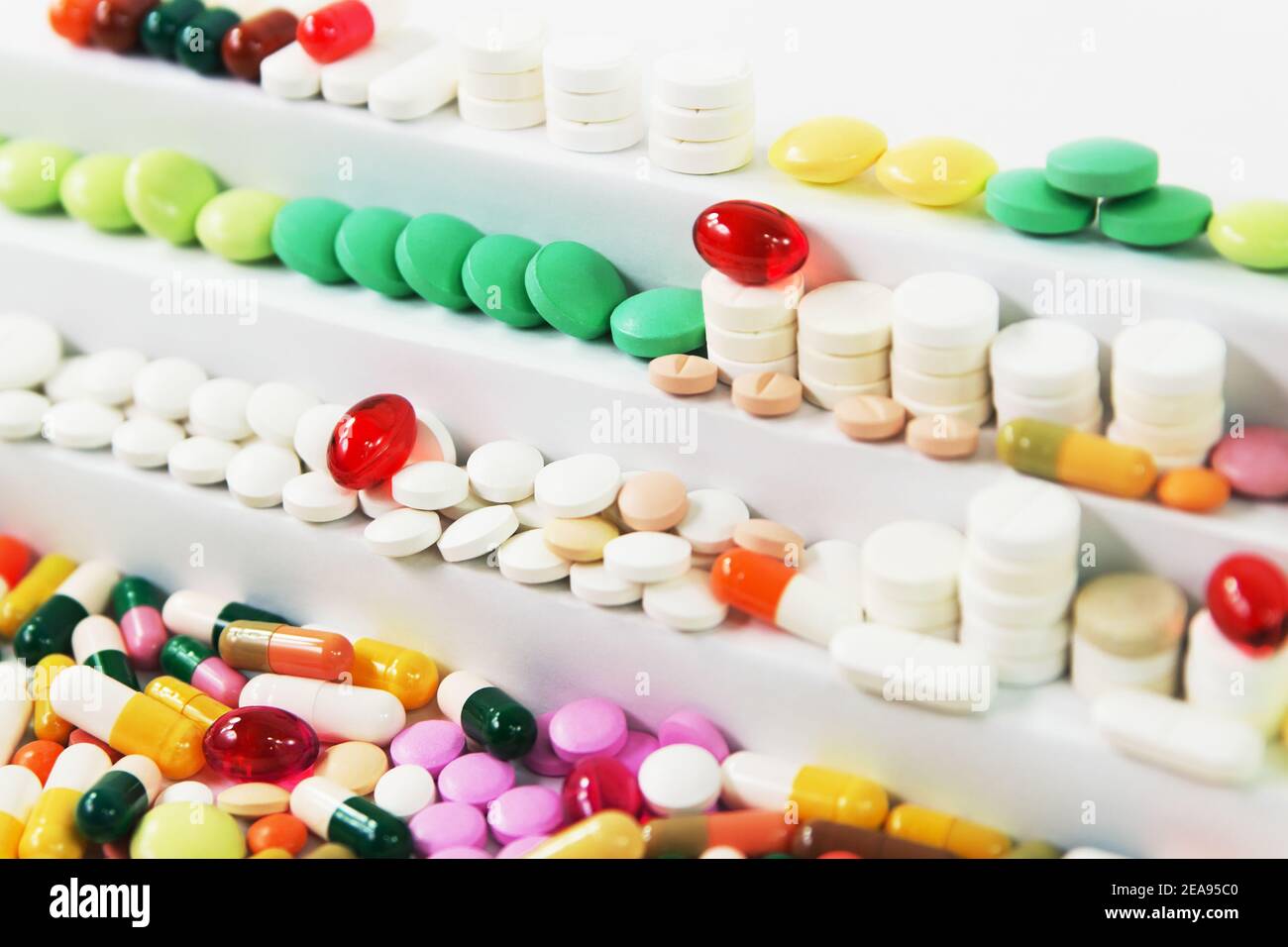 Many various medical pills in rows on stairs Stock Photo