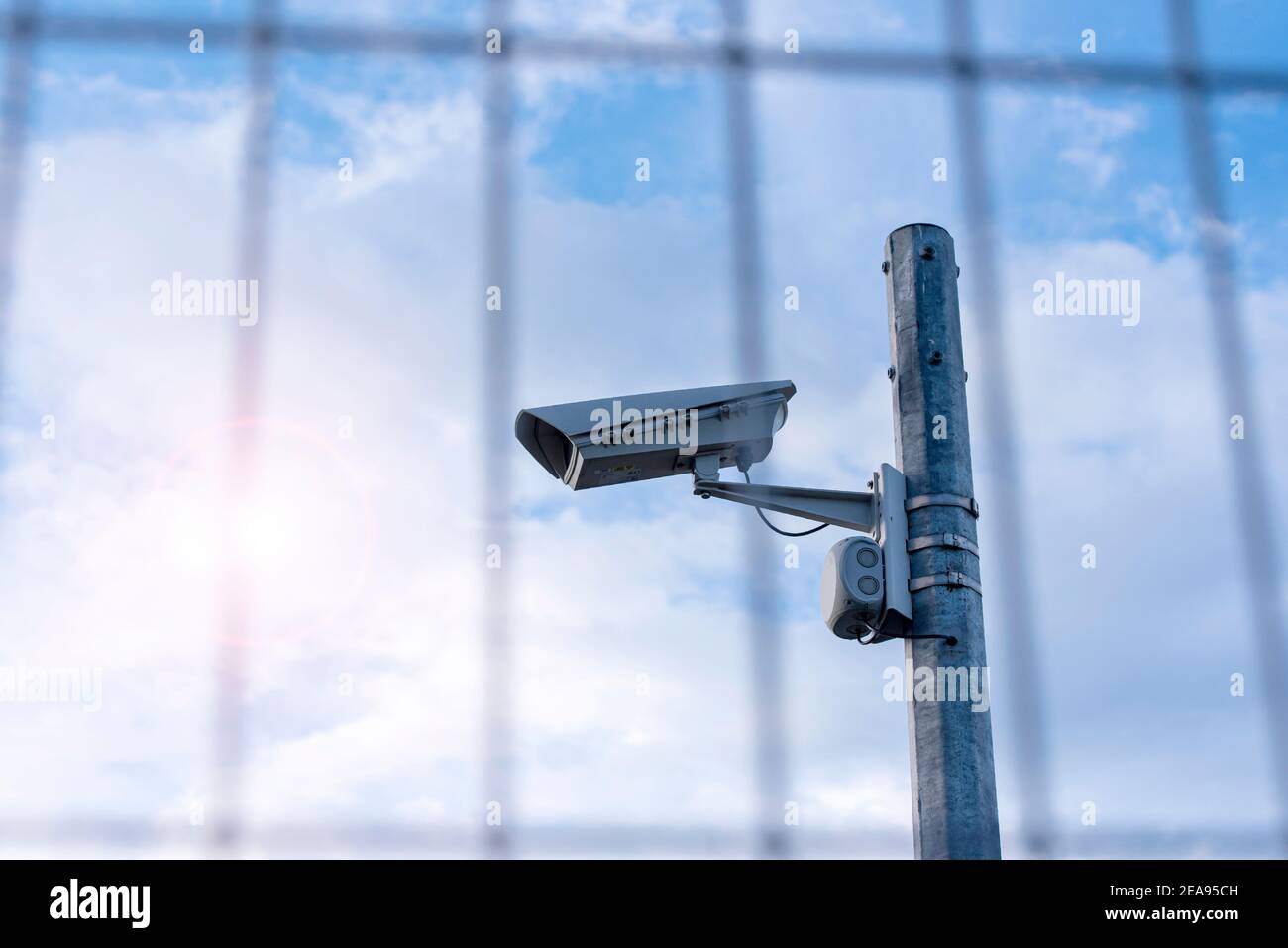 Street security camera next to iron fence, border, prison, concept picture Stock Photo