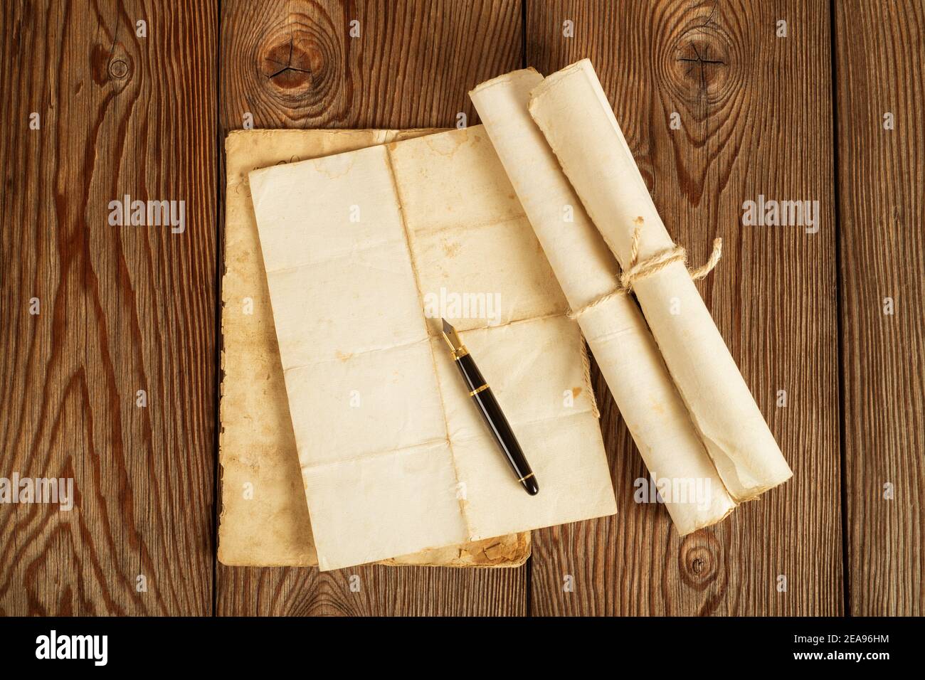 Fountain pen  with old sheets on wood background Stock Photo