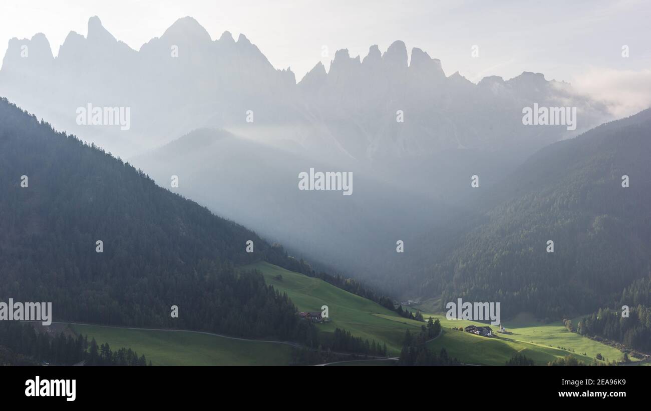 Sunrise over Val di Funes / Vilnöß. Below in the sunlight the church of Santa Maddalena in the background the Geisler group Stock Photo