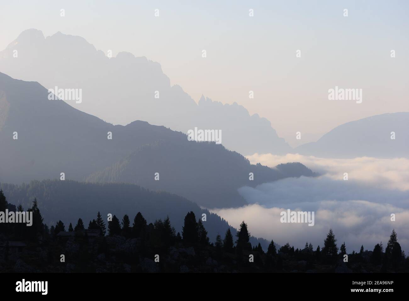 Sunrise at Cinque Torri in the Dolomites, South Tyrol, Italy. In the valley there is a sea of fog, over which various mountain ranges extend Stock Photo
