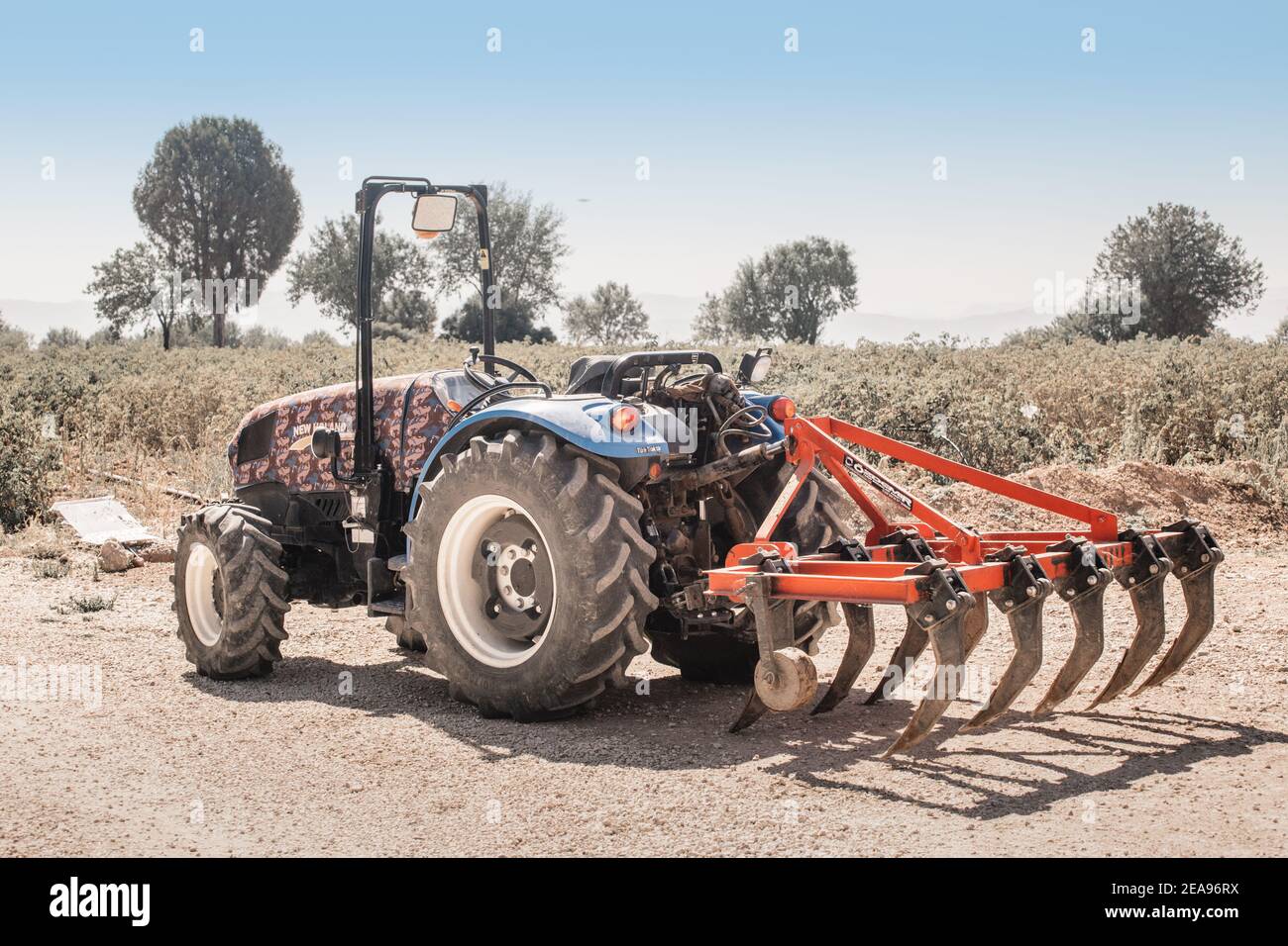 07 September 2020, Isparta, Turkey plow for cultivating the soil is attached to a dusty tractor