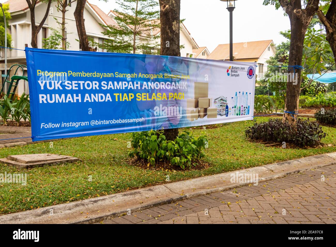 Jakarta, Indonesia - ‎June ‎24, ‎2020: A banner encouraging plastic and waste recycling in an Indonesian Compound, Jakarta Indonesia. Translation "Giv Stock Photo
