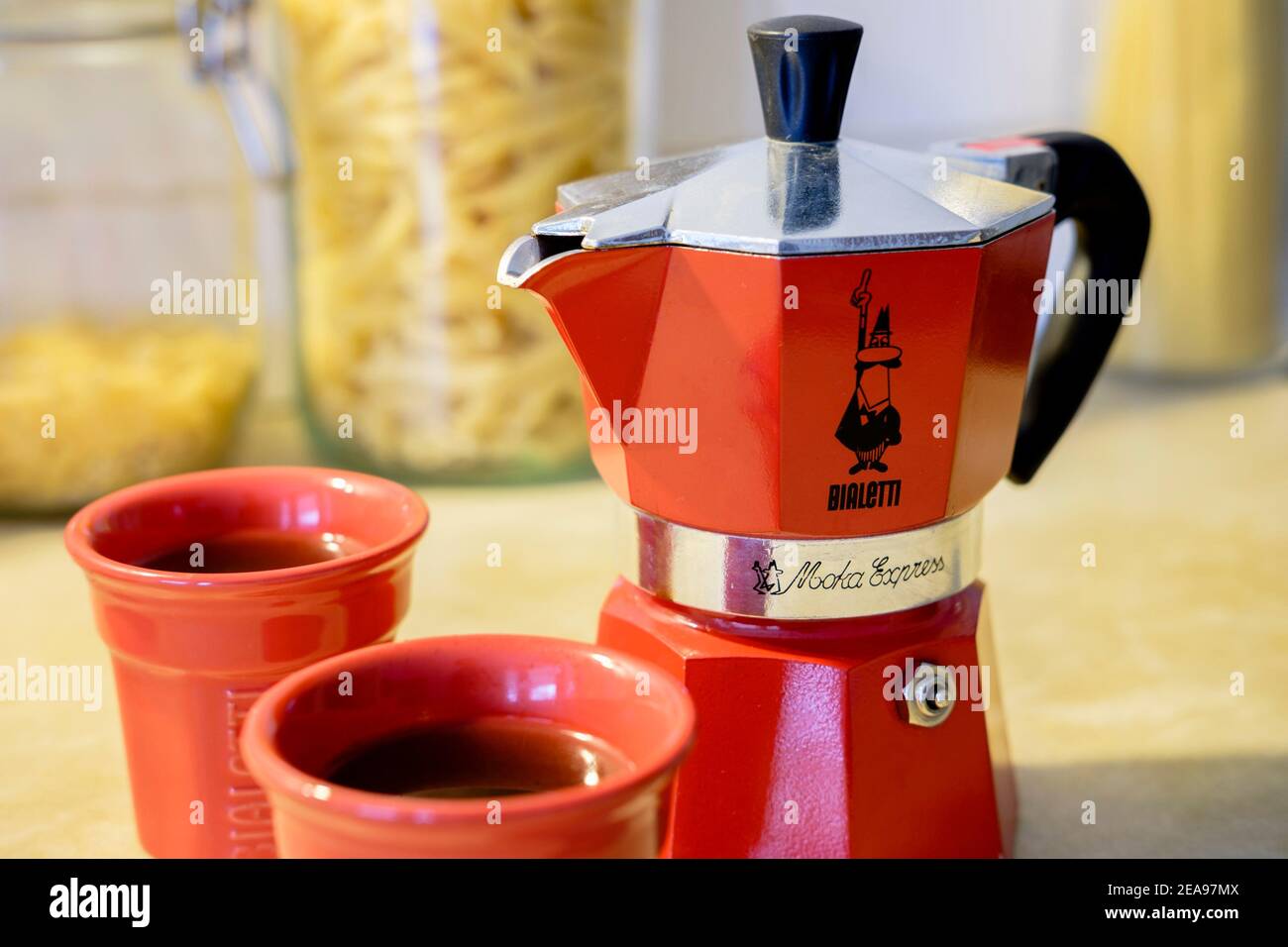 Bialetti Moka Express stove top coffee pot and cups. Stock Photo