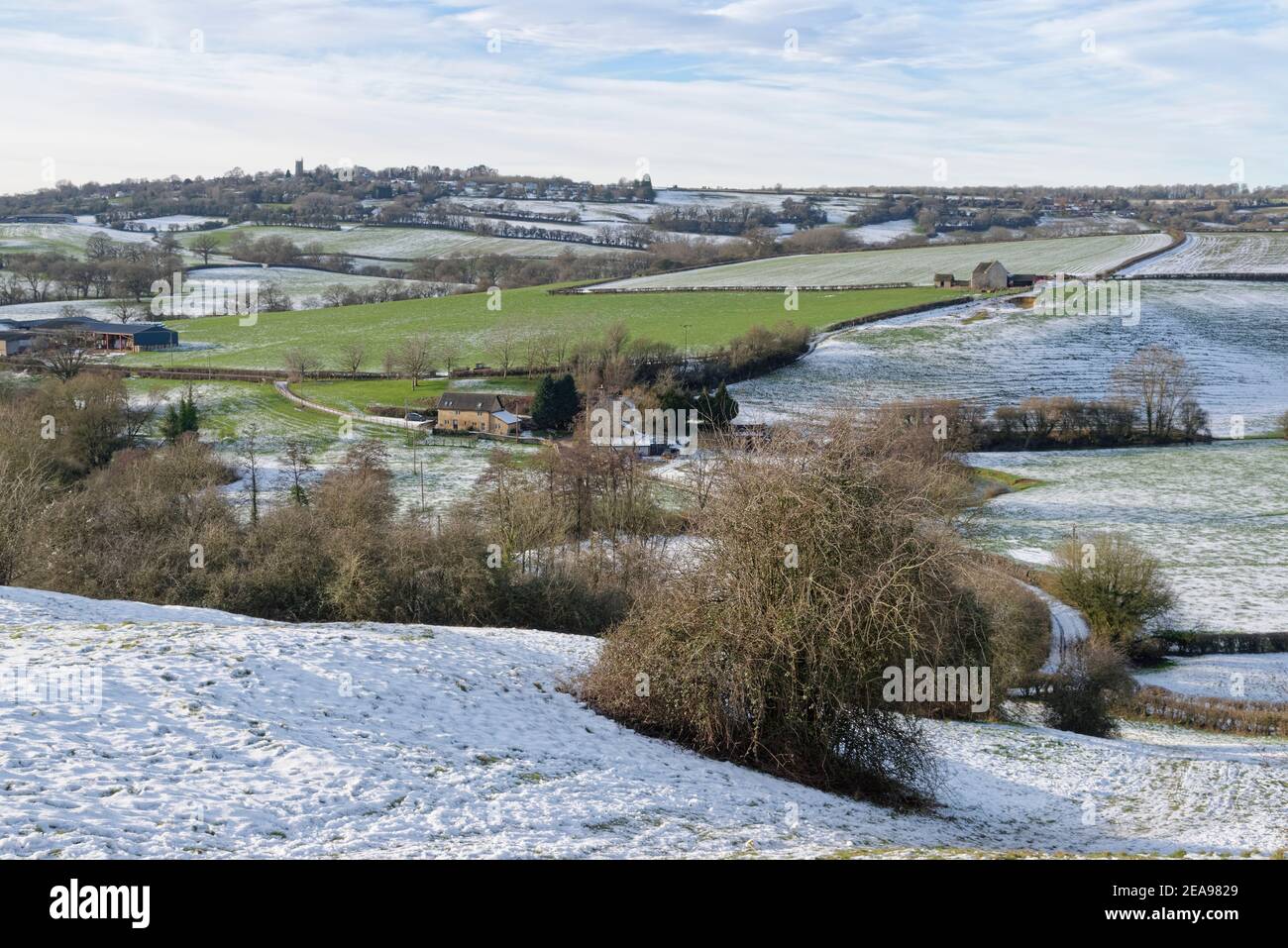 Snow-dusted pastureland, Bybrook Valley and Colerne village, Wiltshire ...