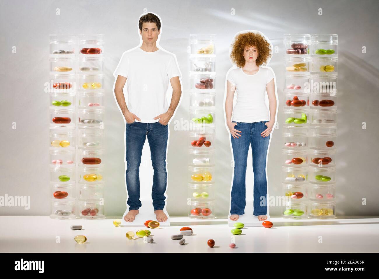 Collage, man and woman, in jeans, in front of tablet tubes, with tablets, studio Stock Photo