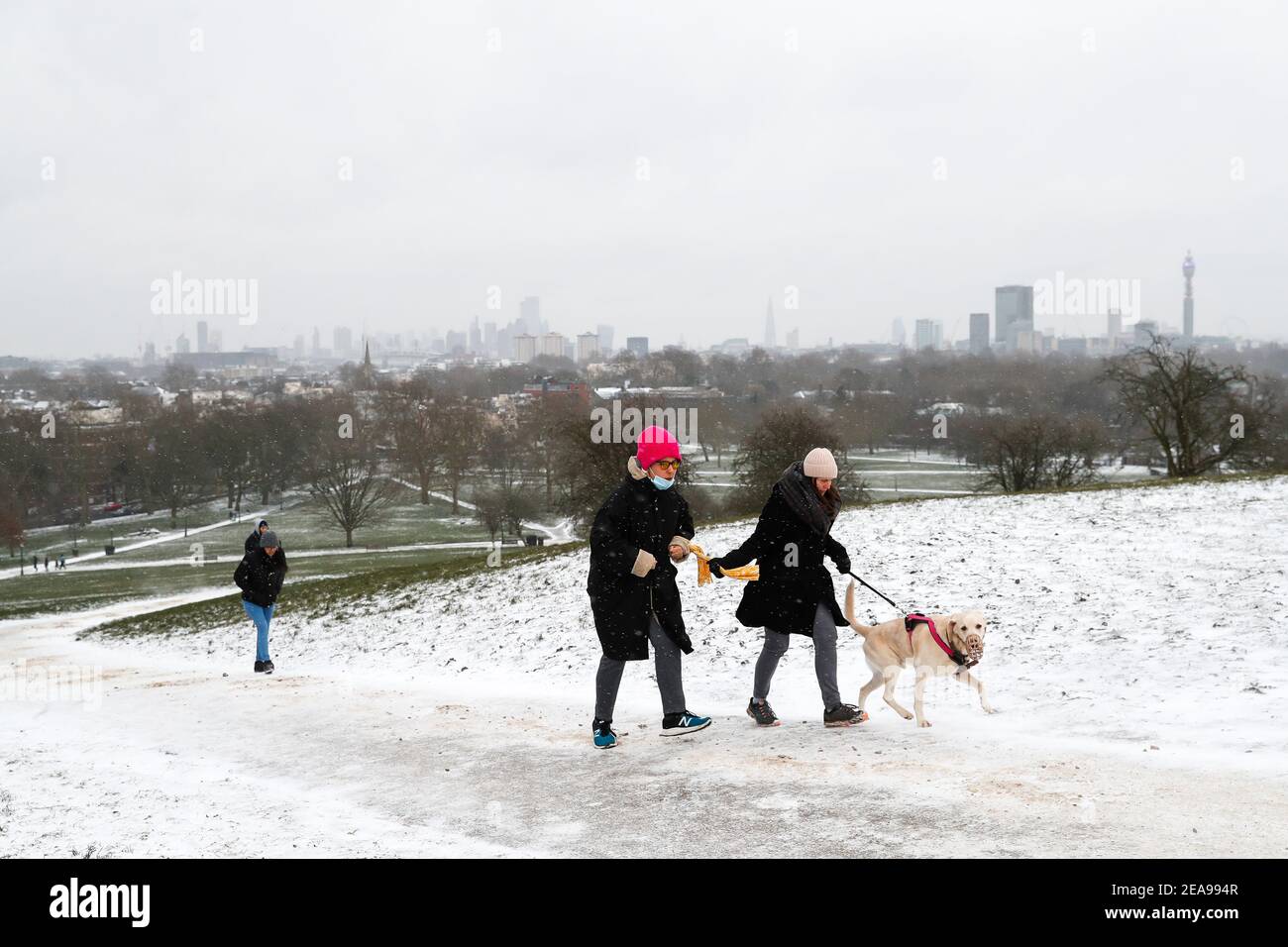 London, Britain. 8th Feb, 2021. People climb up the hill in the snow in London, Britain, on Feb. 8, 2021. TO GO WITH 'Snow, ice warnings issued for most parts of UK' Credit: Han Yan/Xinhua/Alamy Live News Stock Photo