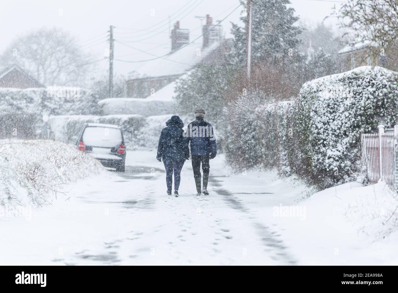 A couple taking a walking during a snowstorm blizzard. Beast from the east 2021, extreme weather Stock Photo