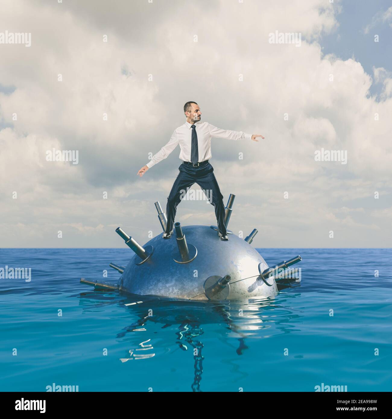 businessman rides a mine into the sea. concept of danger and risk. Stock Photo