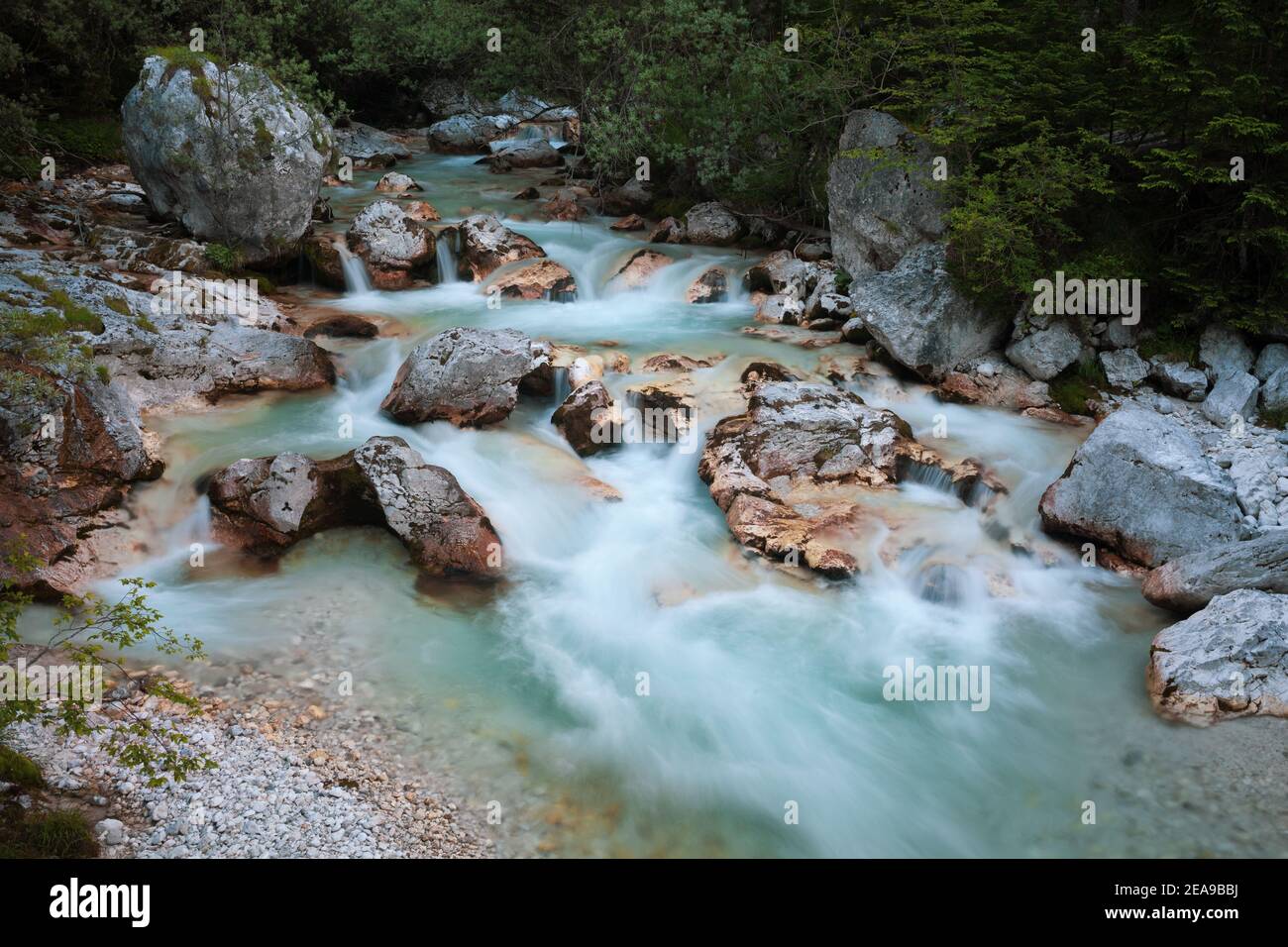 The emerald river Soča in its upper course with numerous rapids and rocks in the riverbed Stock Photo