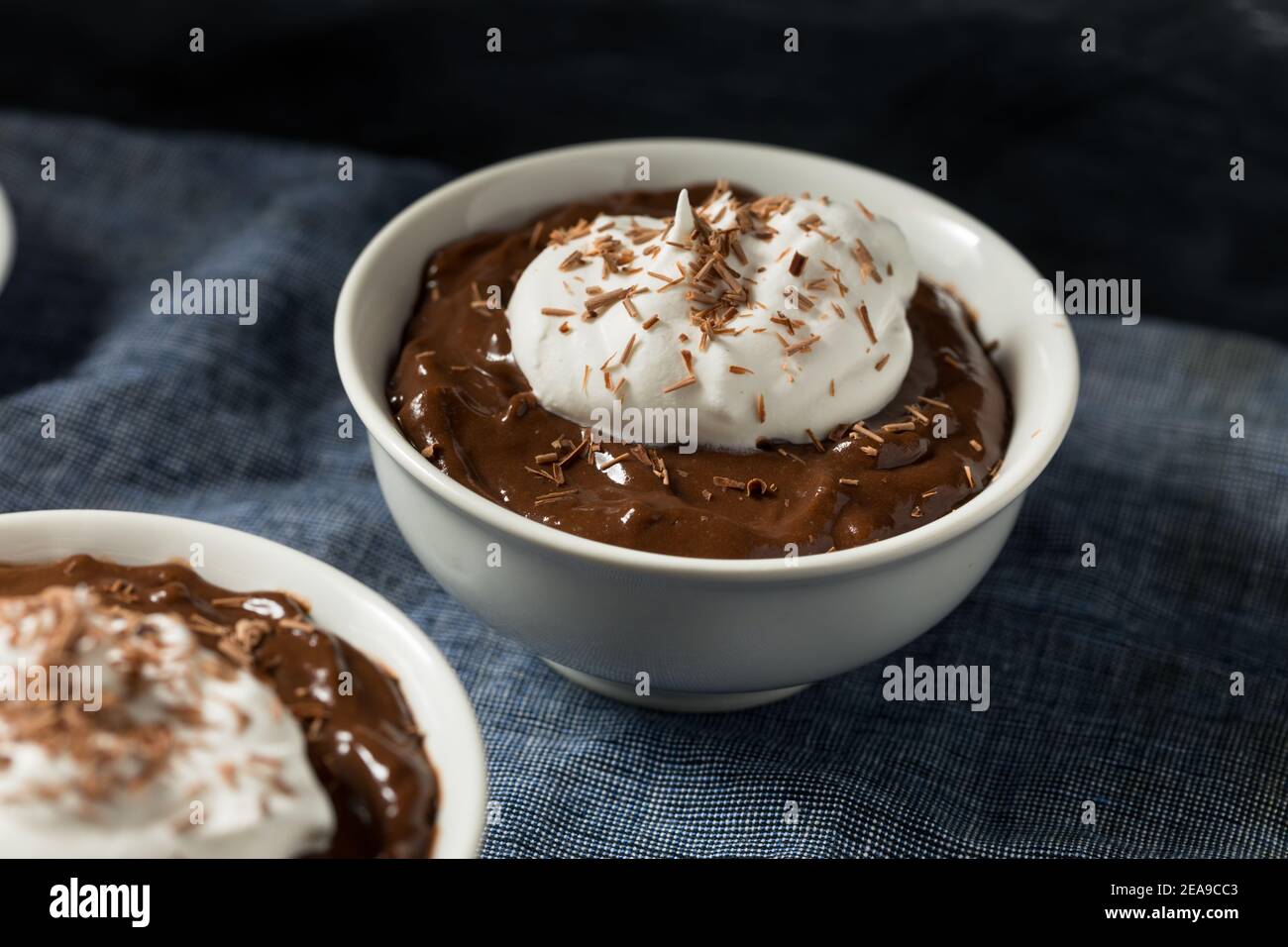 Sweet Homemade Chocolate Pudding in a Bowl with Whipped Cream Stock