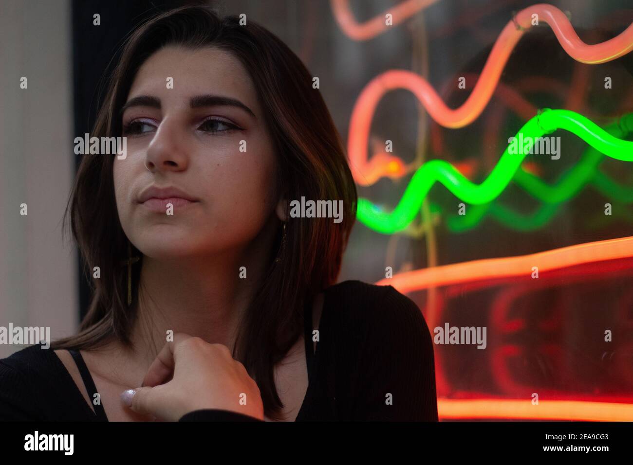 Closeup portrait of a young beautiful woman in front of a burger joint Stock Photo
