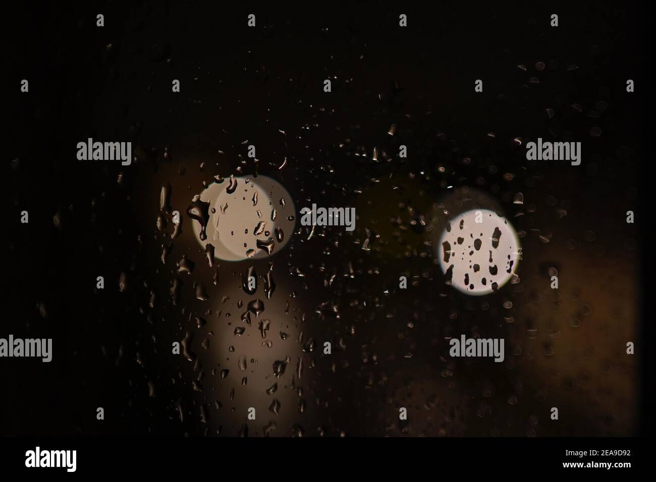 Closeup of raindrops on a car window with reflected lights Stock Photo ...