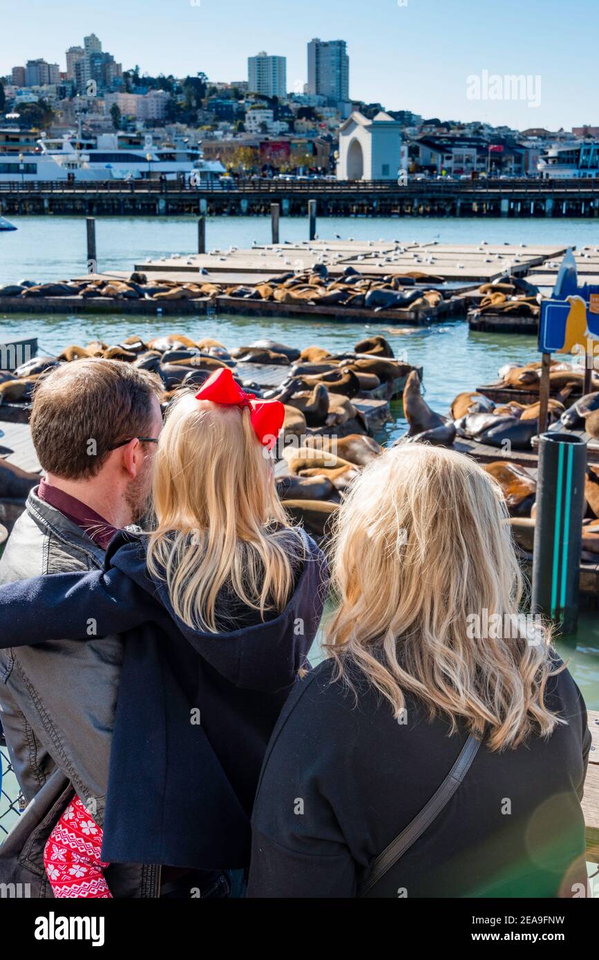 Family with three-old-girl at Pier 39 watching the sea lions. San Francisco, California. Stock Photo