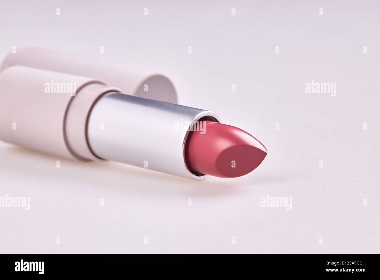 Beautiful pink lipstick in the matt container isolated on white
