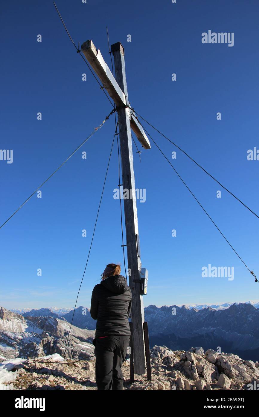 Hike to the Pleisenspitze (2569m), young woman, mountain tour, mountain hiking, outdoor, summit cross, mountain cross Stock Photo
