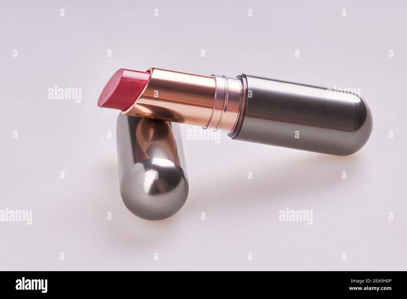 Beautiful pink lipstick in the matt container isolated on white