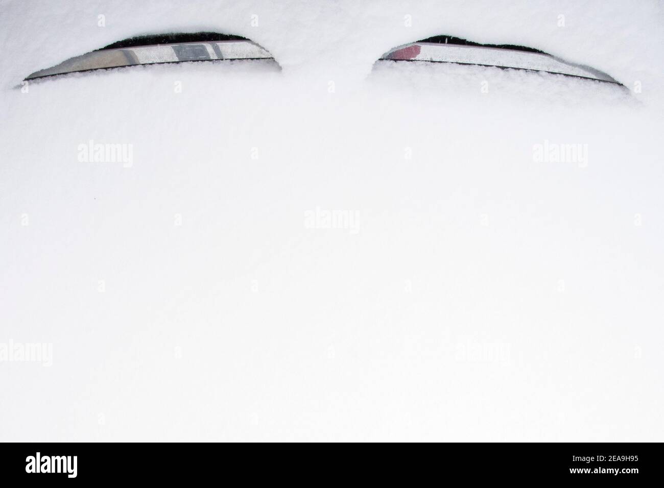 Poznan, Wielkopolska, Poland. 8th Feb, 2021. Winter attack in Poland. There are quite a few images around us that can cheer us up or make us reflect. Winter can be very photogenic. In the picture: eyes on the hood of the car. Credit: Dawid Tatarkiewicz/ZUMA Wire/Alamy Live News Stock Photo