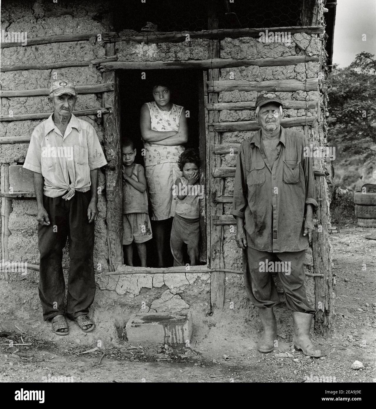 indigenous family in front of typical adobe house in Lara state, Venezuela , South America. Stock Photo