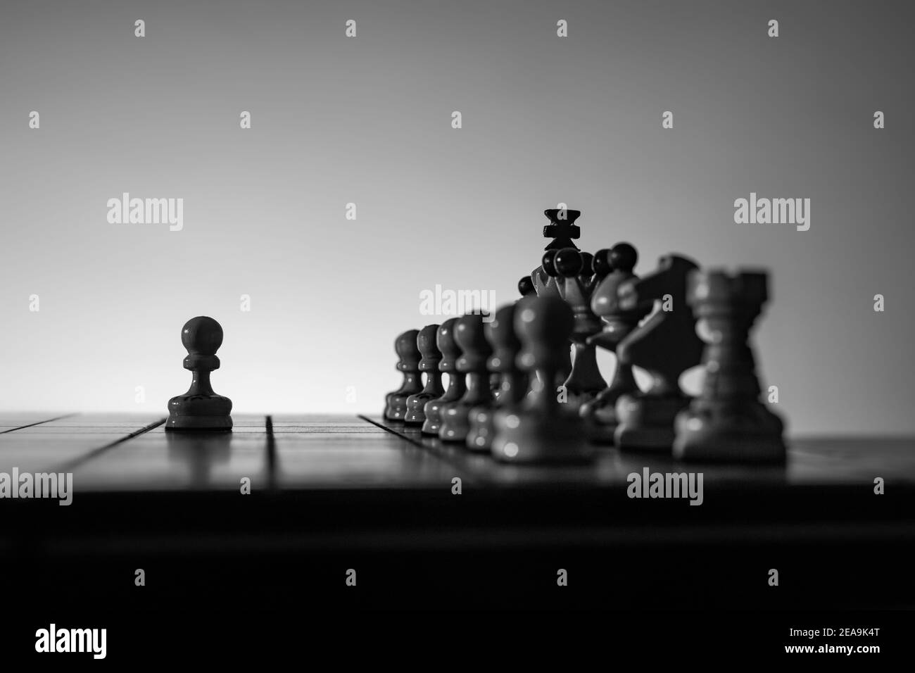 Game of chess. Board with chess pieces silhouettes on white background. Concept of business ideas and competition and strategy ideas. Black and White Stock Photo