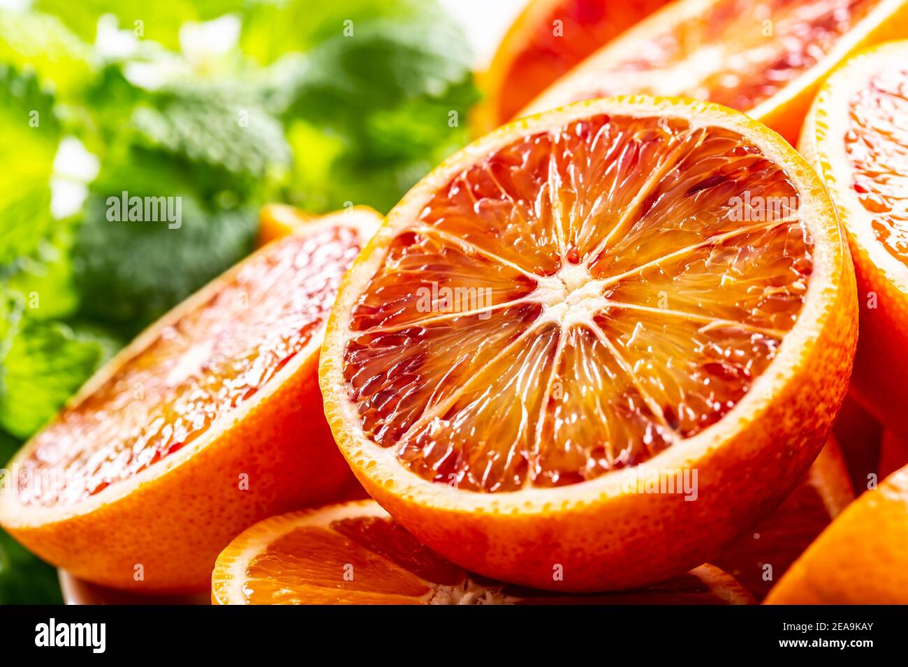Blood sicilian oranges sliced with fresh melissa - close up Stock Photo