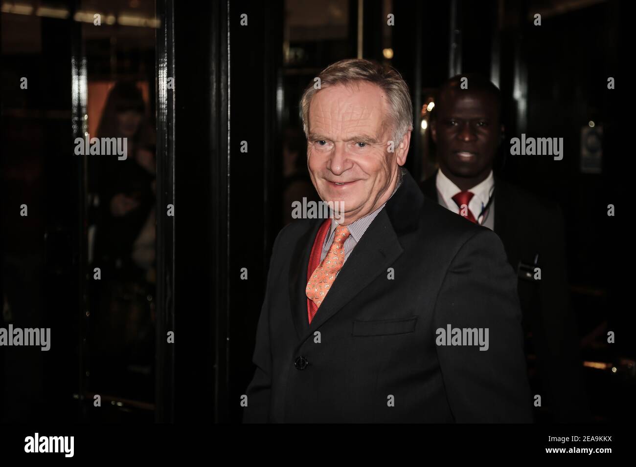 Jeffrey Archer posing for photos on the red carpet before attending the