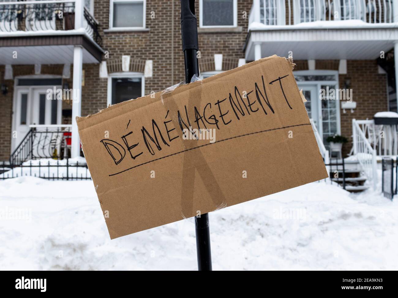 February 6, 2021 - Montreal, Qc, Canada: Moving Day Sign in front of apartments to secure parking space on a narrow street in winter Stock Photo