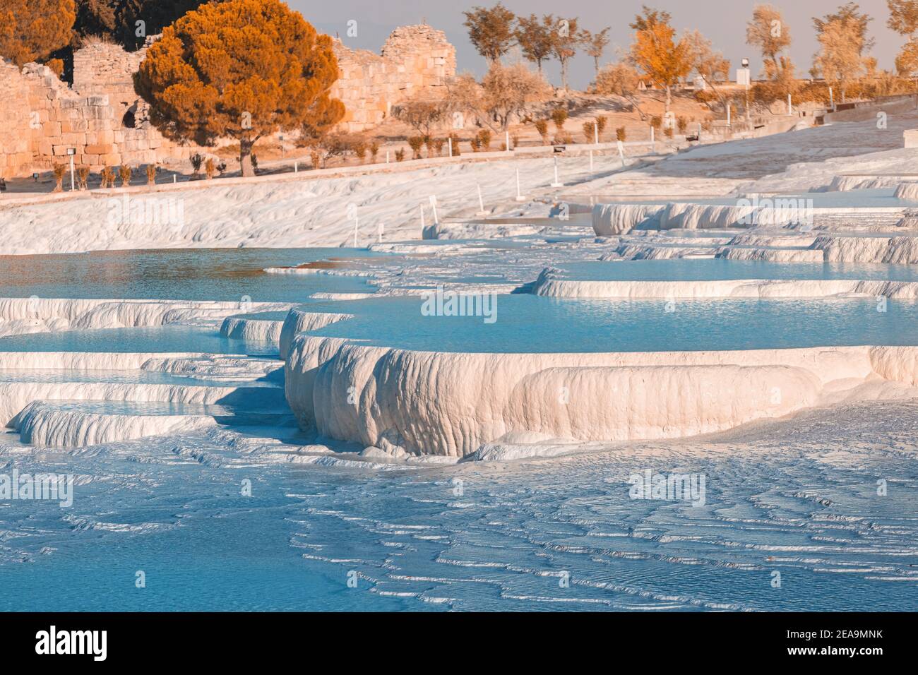 Famous travertines in the Turkish resort of Pamukkale near the city of Denizli. White mineral rock outcrops and thermal water sources. Wonder of natur Stock Photo