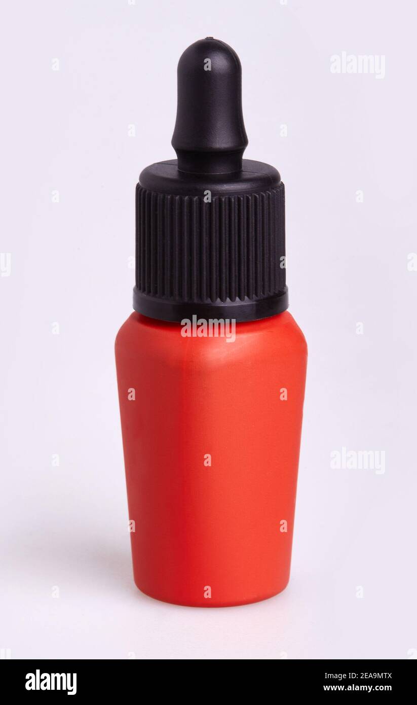 Red blank bottle of lip tint with black lid on a white background. Beauty makeup cosmetics Stock Photo