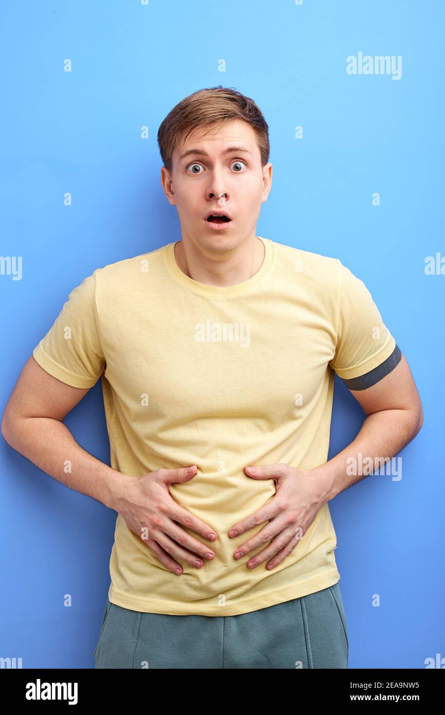 man having painful stomach ache, chronic gastritis or abdomen bloating