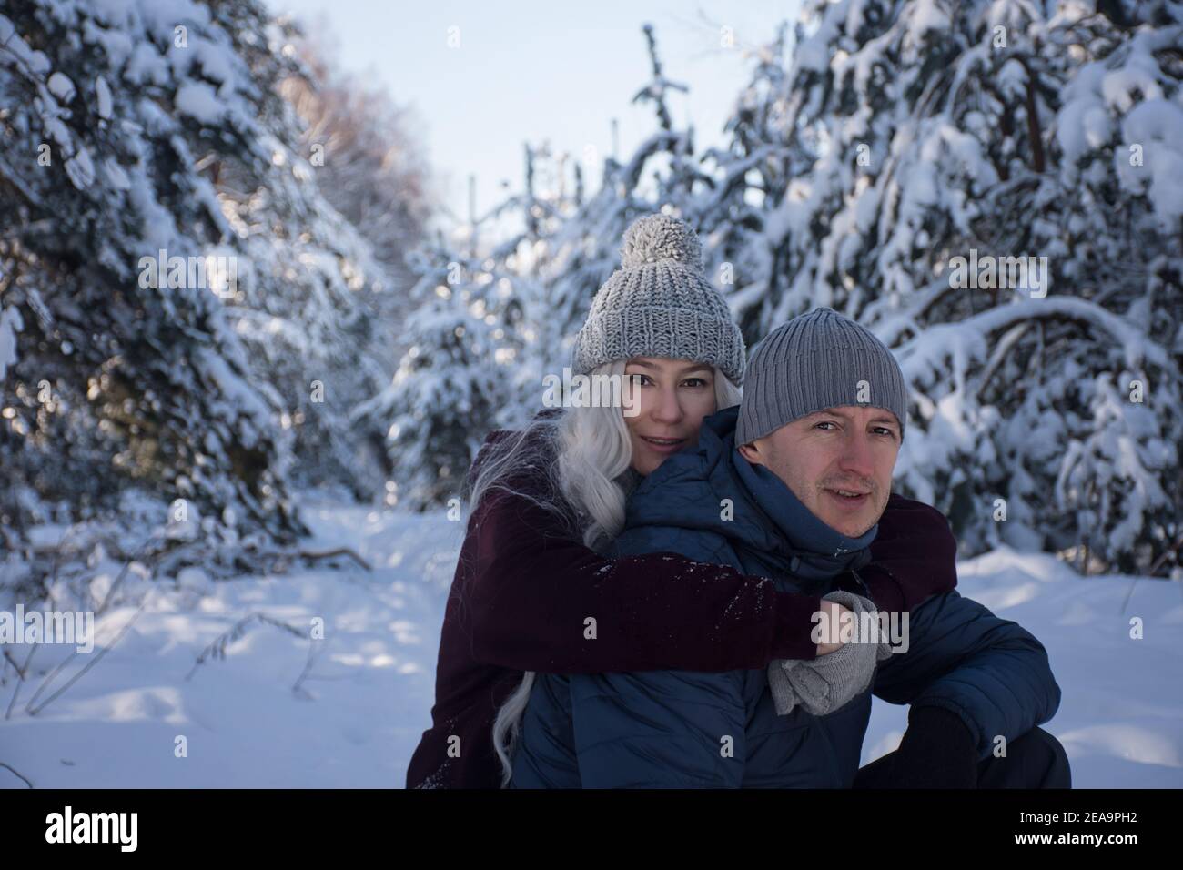 happy couple hugging on a walk in the snowy forest Stock Photo - Alamy