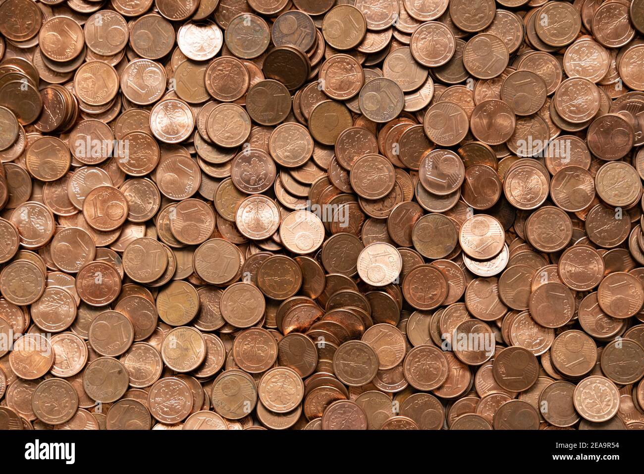 A lot of small euro cent coins from change. Thousands of hard cash pieces in copper color Stock Photo