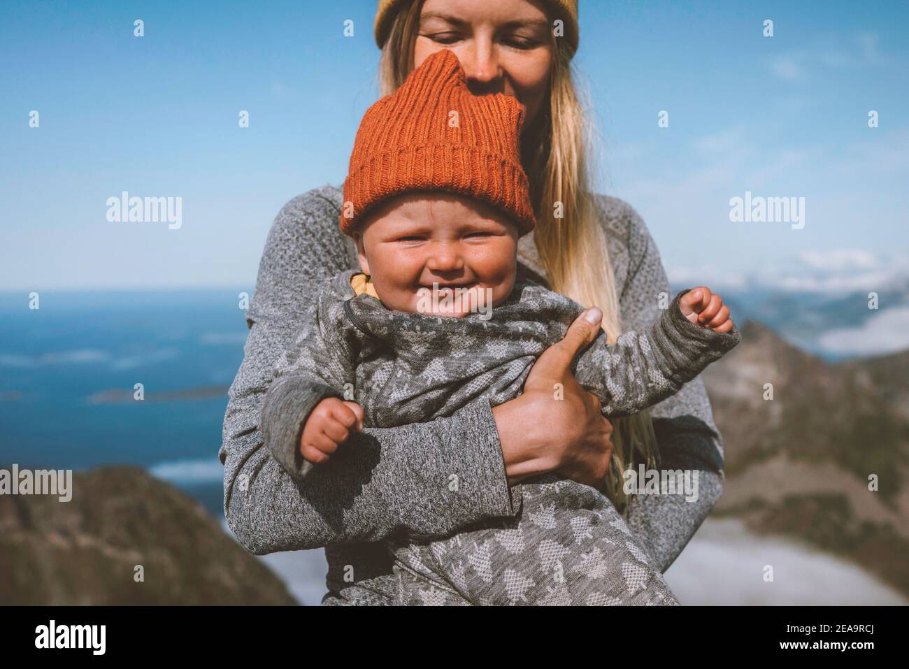Baby with mother family travel lifestyle vacation woman hiking with infant child happy emotions healthy lifestyle kid smiling portrait outdoor Stock Photo