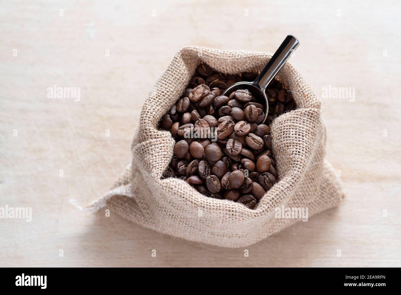 Coffee beans in a rustic jute bag Stock Photo