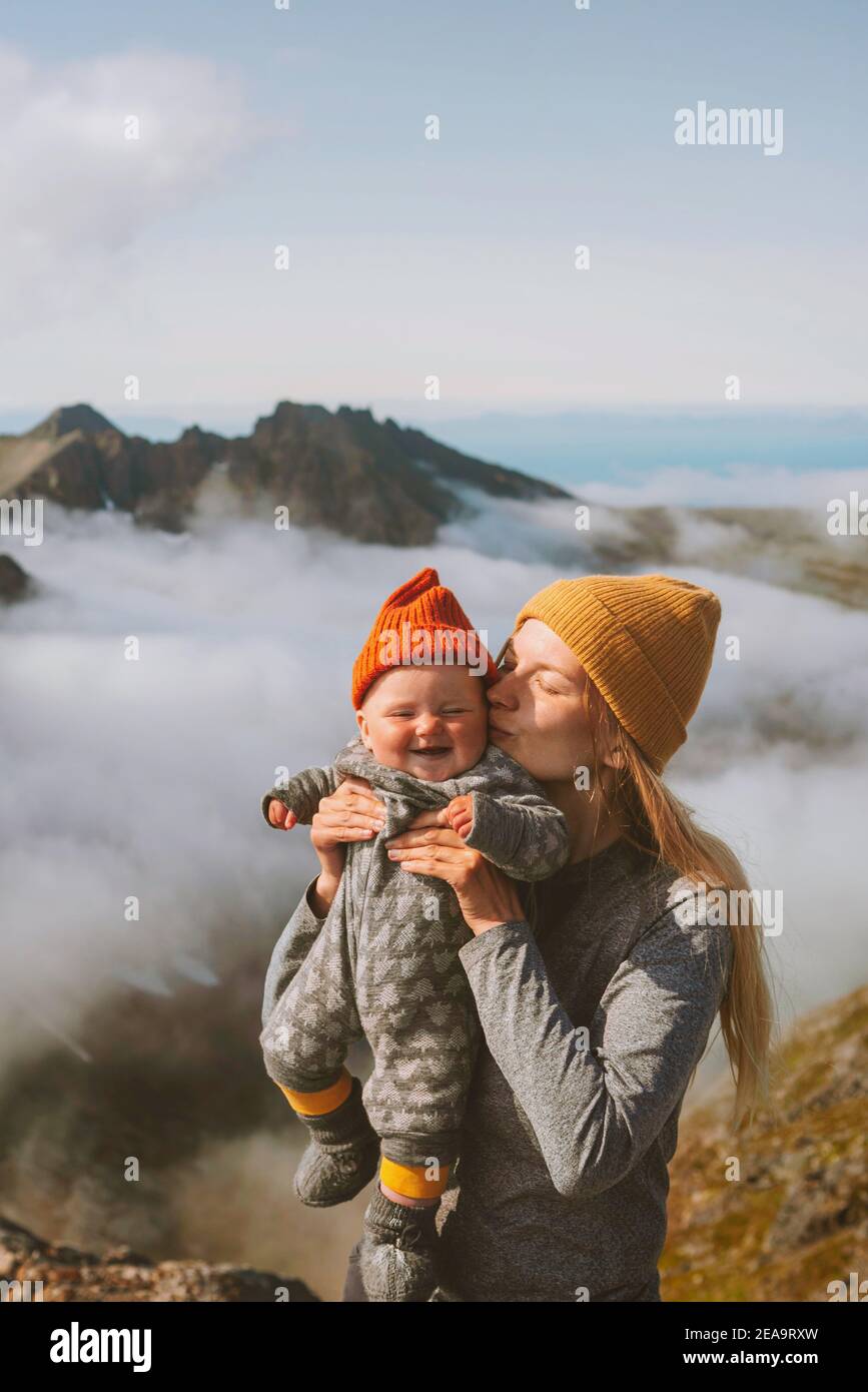 Baby with mother traveling hiking family vacation outdoor active vacations woman mom with daughter kid enjoying mountains view healthy lifestyle tour Stock Photo