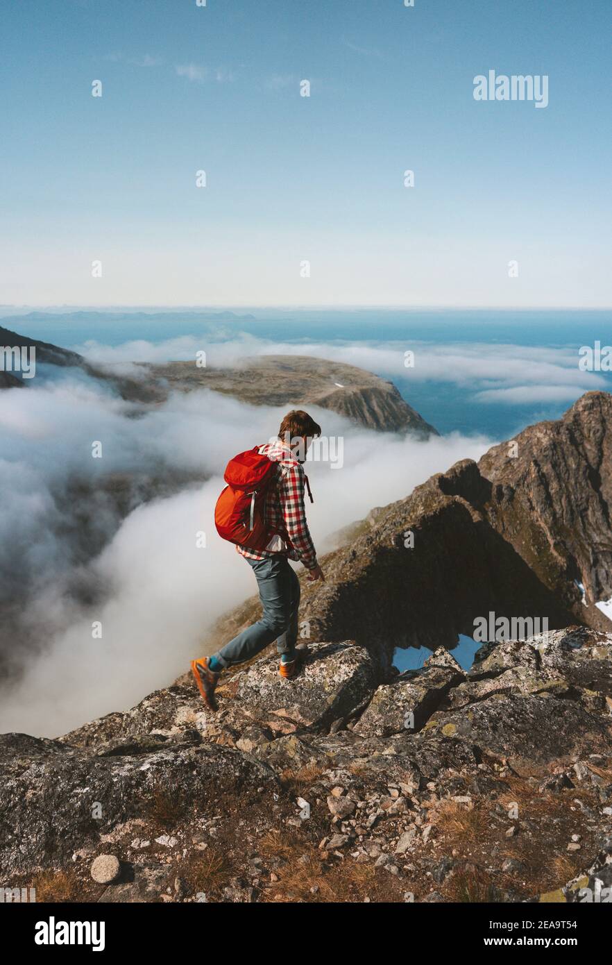 Man hiking solo on mountain ridge travel lifestyle adventures active outdoor vacation tour in Norway eco tourism concept Stock Photo