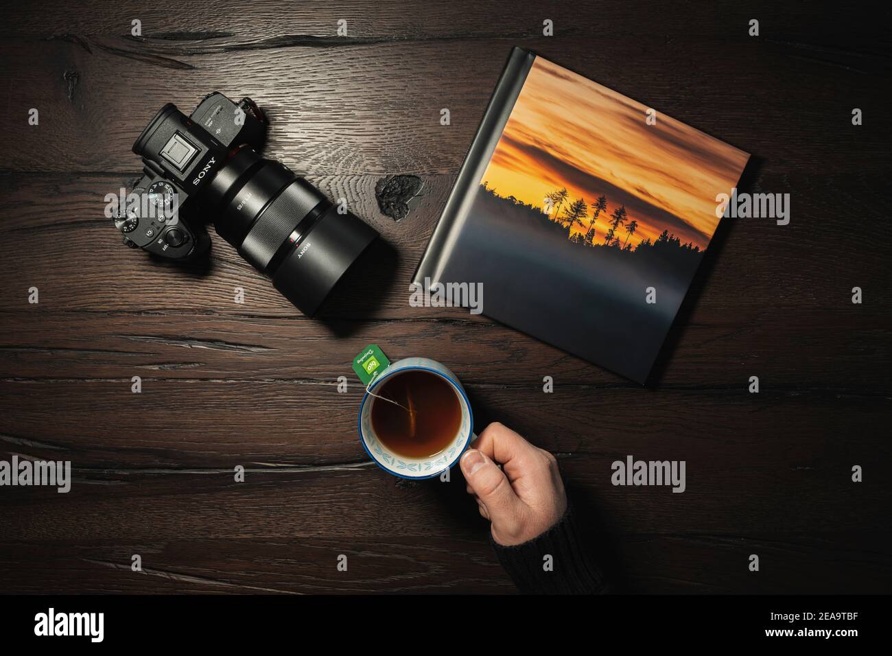 Scene, photo book on table with camera and teacup Stock Photo