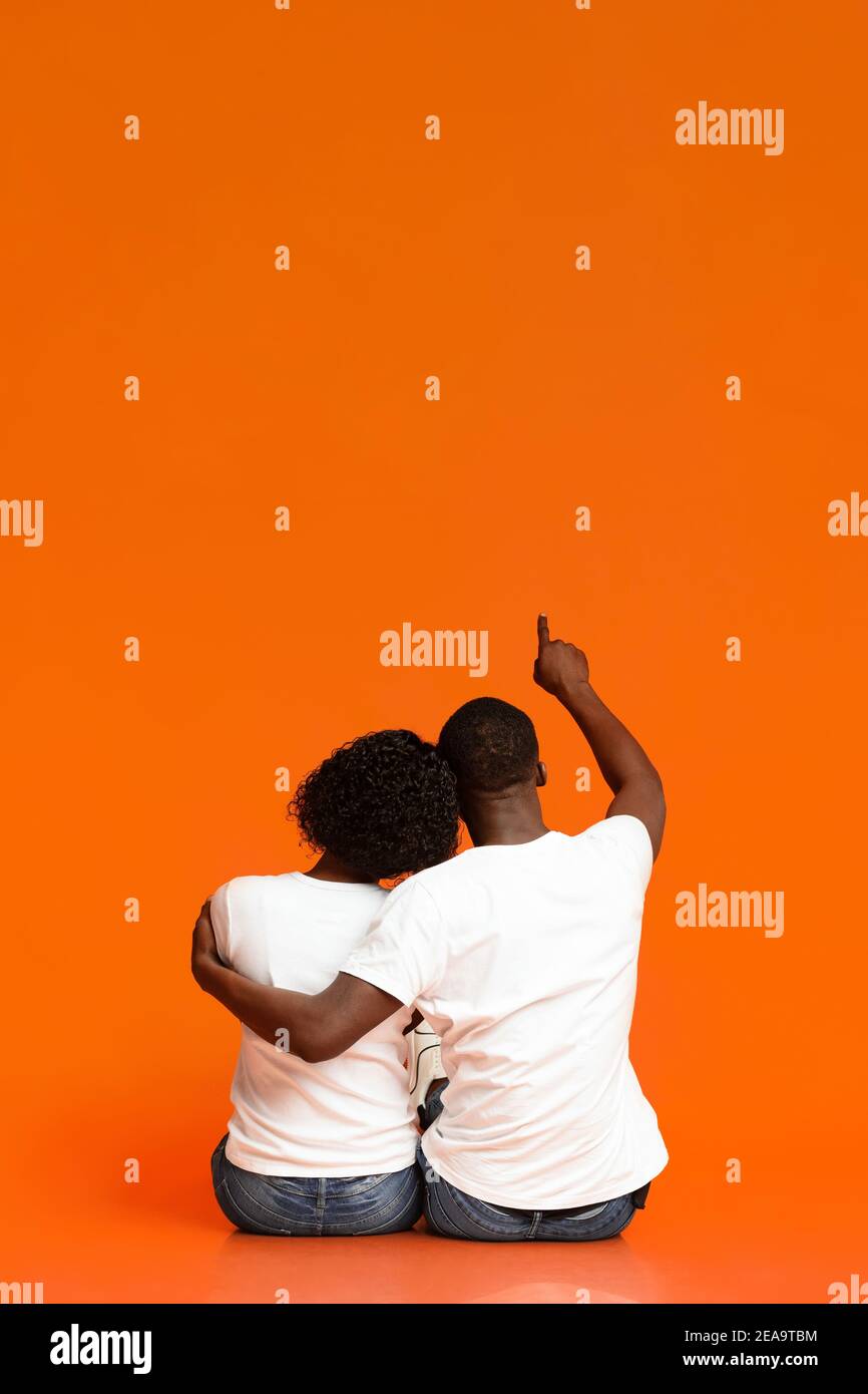 Rear view of black couple sitting on floor together Stock Photo Alamy